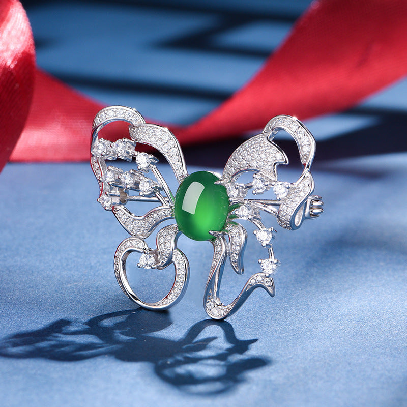Sterling Silver Butterfly Brooch With 8 x 10 mm Green Chrysoprase Cabochon, Platinum-Plated — shown in use
